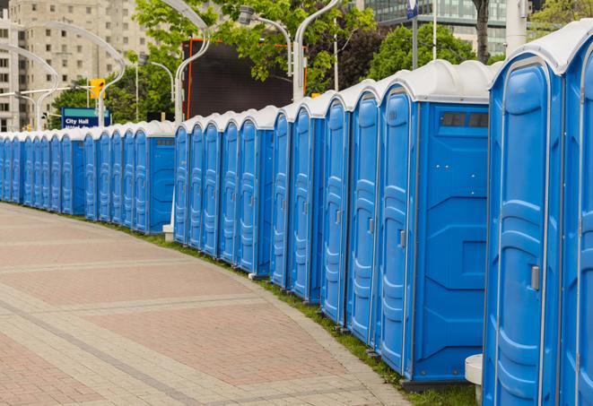 a line of portable restrooms set up for a wedding or special event, ensuring guests have access to comfortable and clean facilities throughout the duration of the celebration in Elm Grove